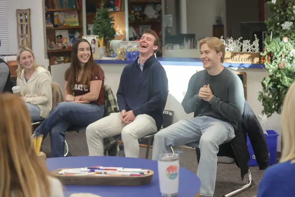 A panel of recent graduates speaks to a group of current parents