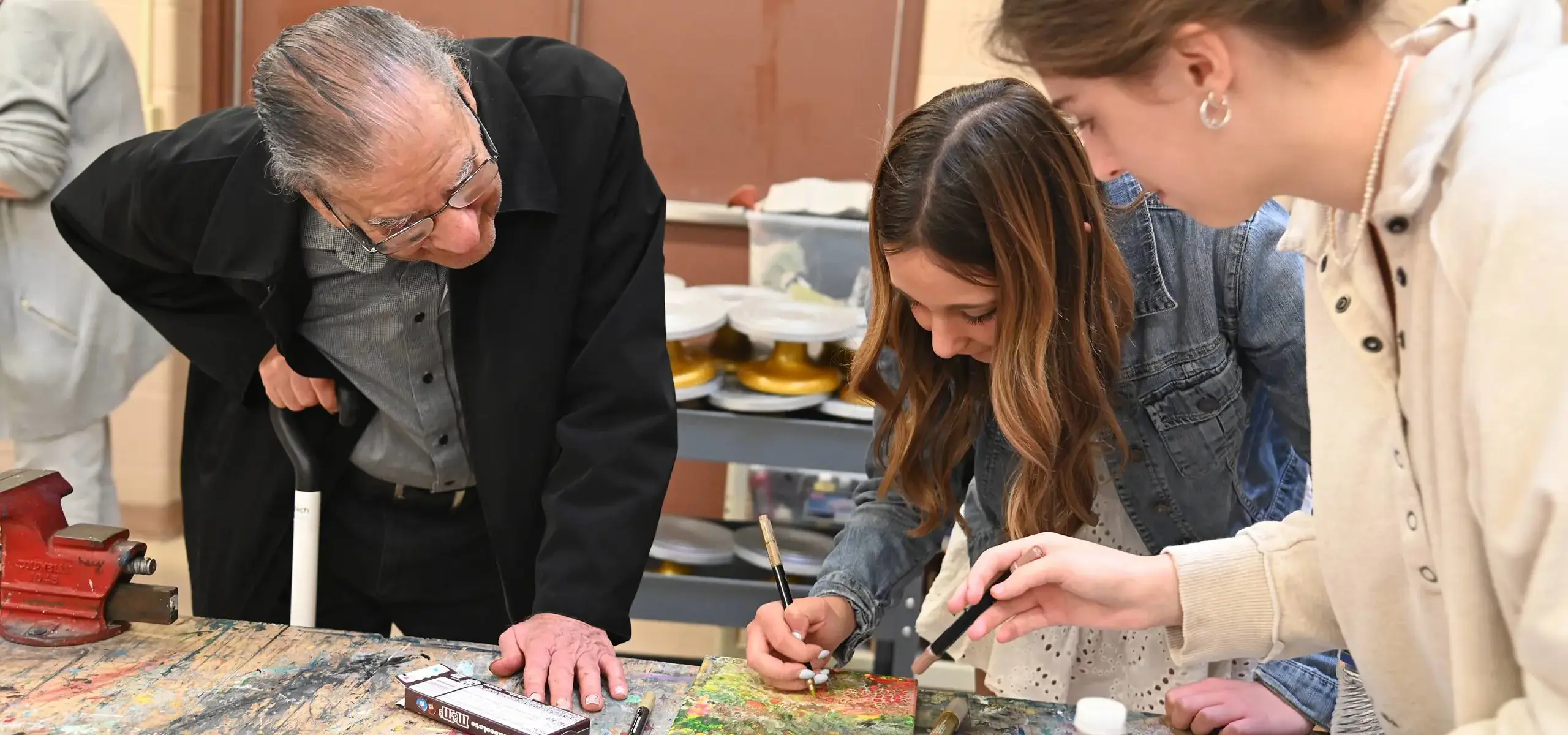 Students working on art project with teacher