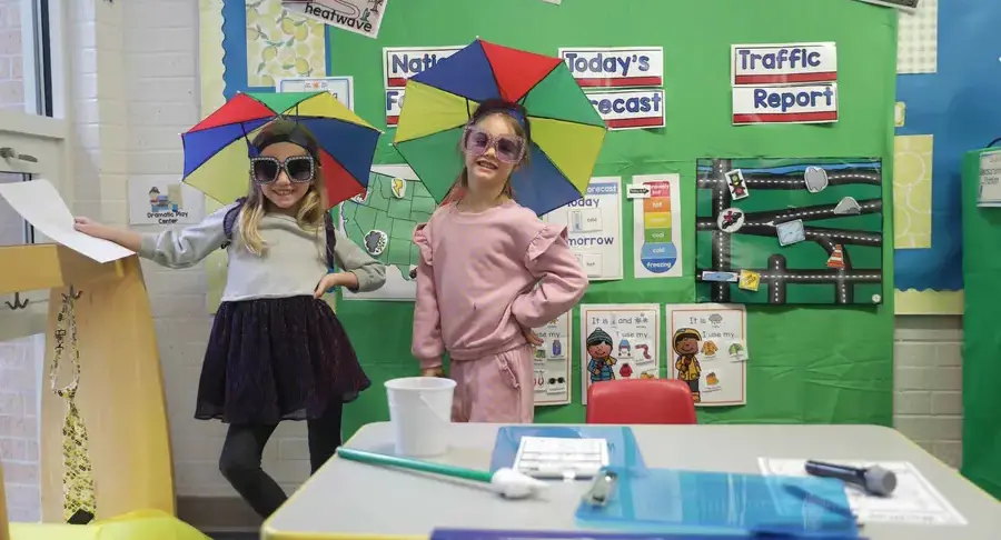 Students showing off science fair project