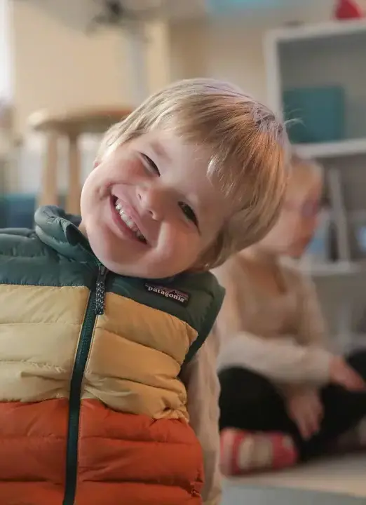 Early childhood student smiling in classroom