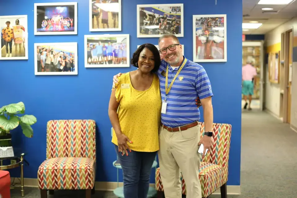 Upper School faculty share a hug and a smile in the office.