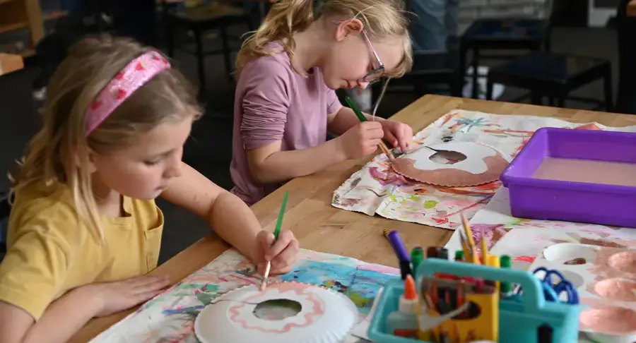 Lower school students painting in class
