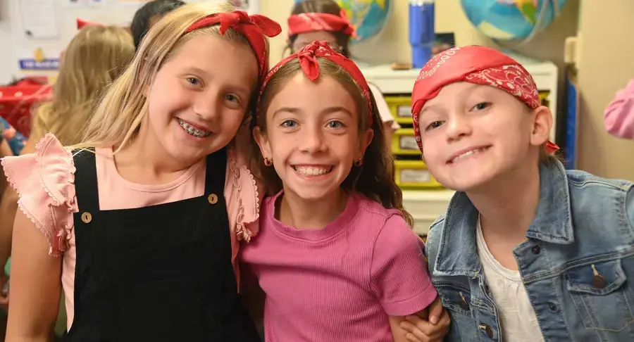 Lower school students smiling and posing