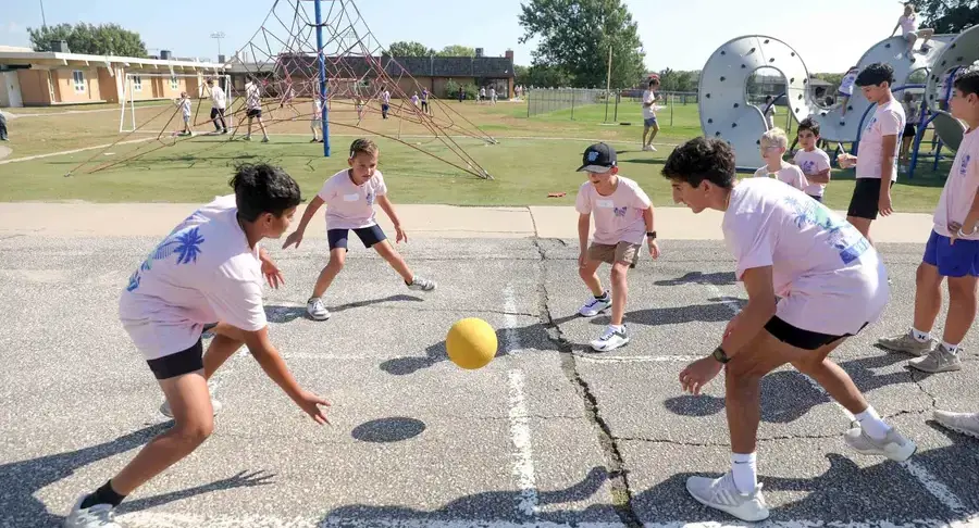 Students playing four square