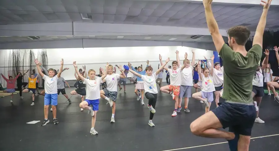 Middle school student participate in a yoga class