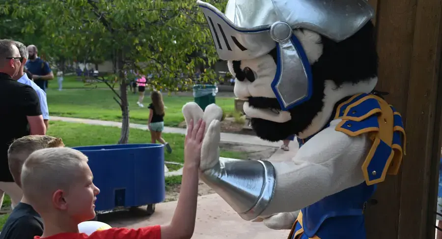 Student high-fives Sparty