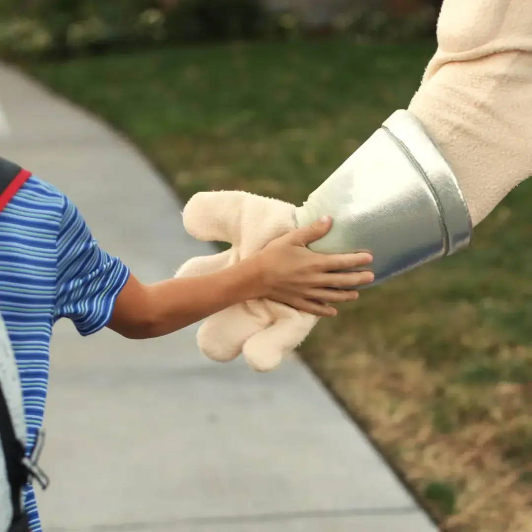 Student and mascot hi-fiving