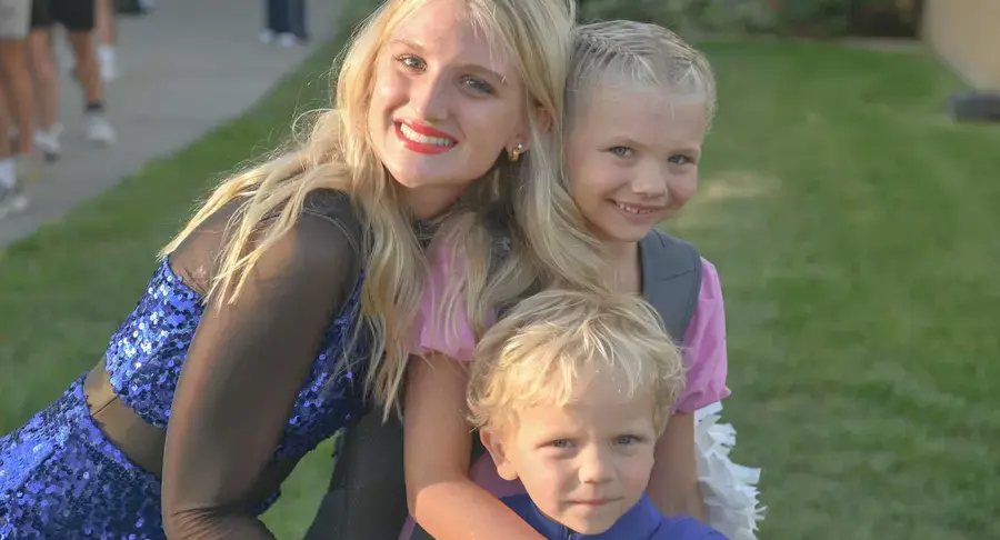 Three students smiling and posing together