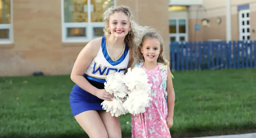 Two students smiling and posing together
